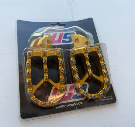 Return, Warp 9 Surron Foot Pegs Gold