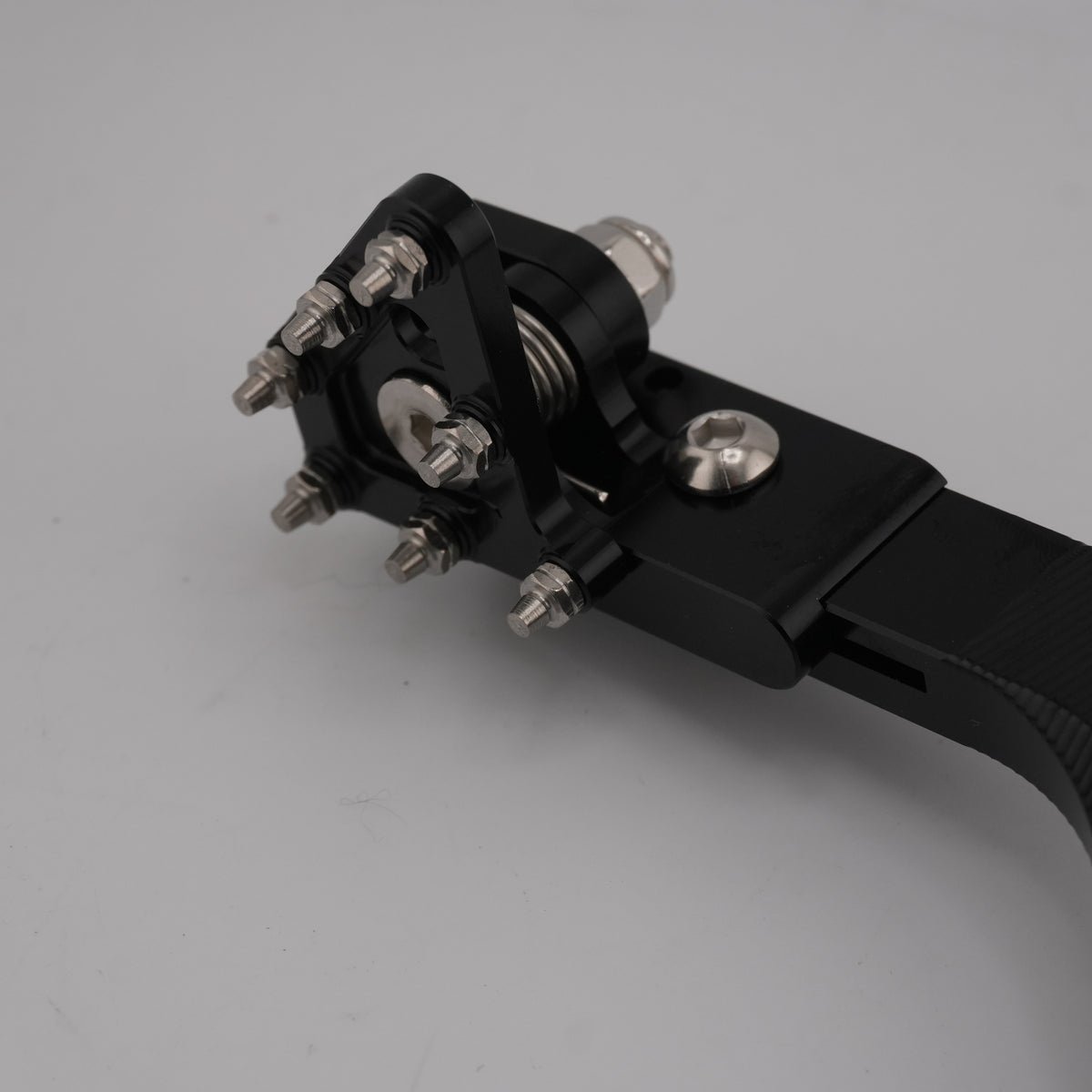 Close-up of the CNC foot brake pedal pivot and spring on the Ultra Bee foot brake kit