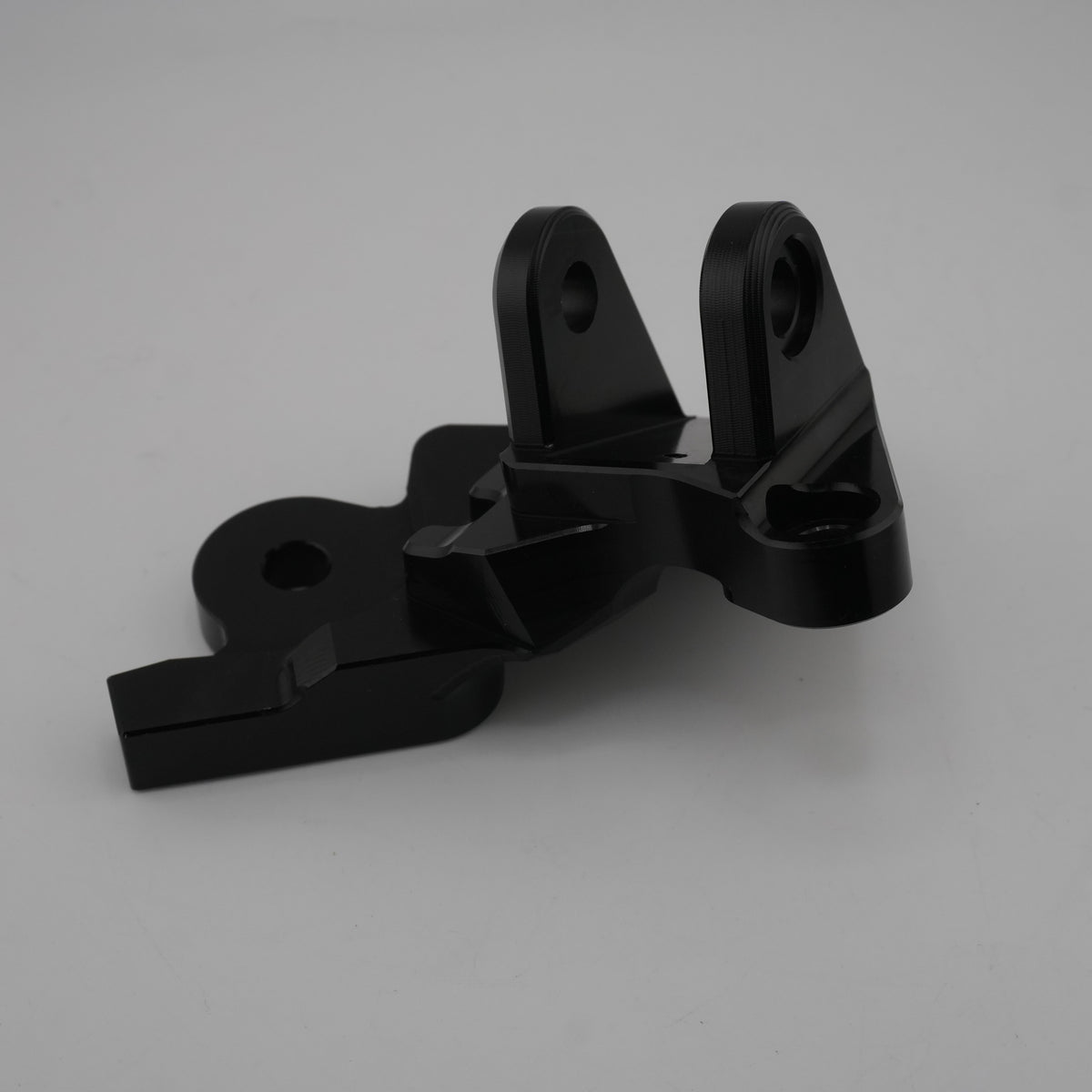Black CNC foot brake bracket from the Sur-Ron Ultra Bee foot brake kit, side angle