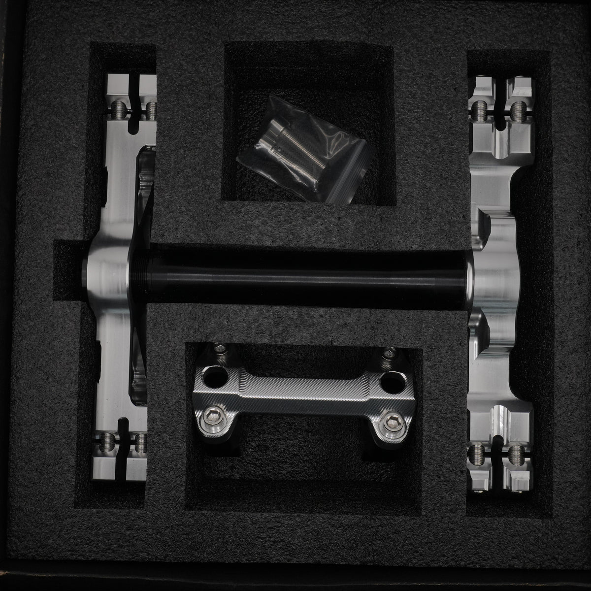 Silver Sur-Ron Ultra Bee CNC triple clamps packed in a foam-lined case with bar clamp mount and hardware