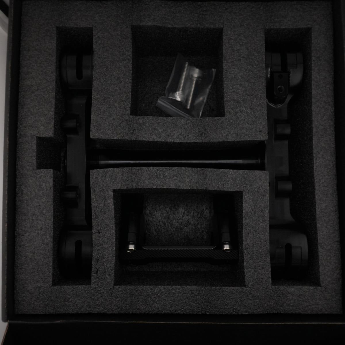 Black Sur-Ron Ultra Bee CNC triple clamps packed in a foam-lined case with bar clamp mount and hardware